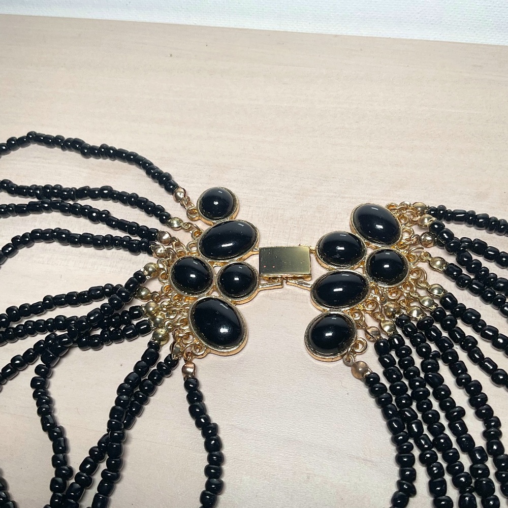 Vintage necklace with black beads and golden detail in excellent condition